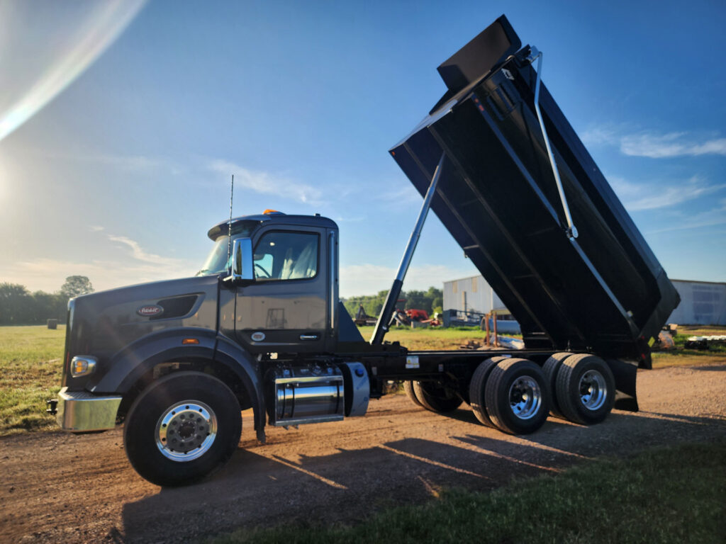 A powerful Peterbilt truck hauling a 17ft Warren half-round trailer.