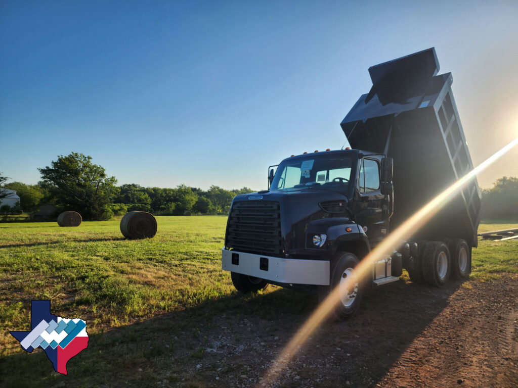 Freightliner truck with Warren FLS-14 dump body in dark blue Elite paint.