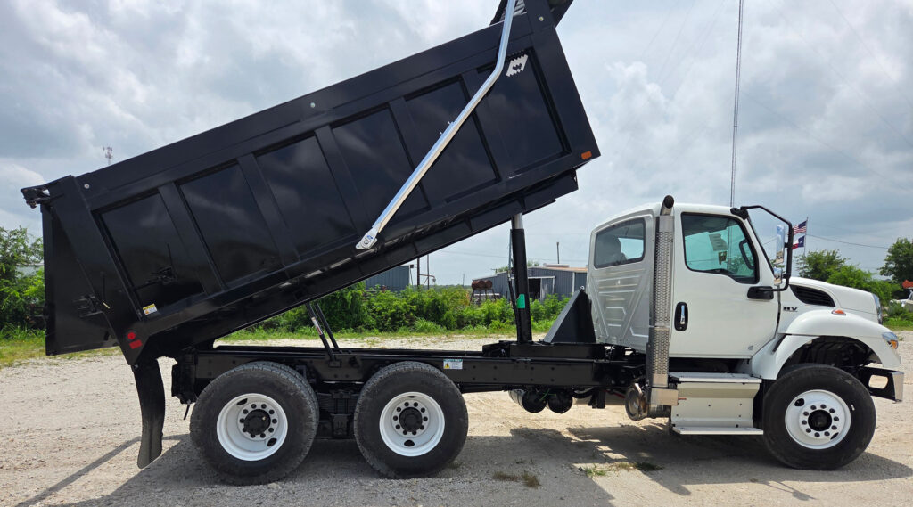 White International FL-15 with the black Warren frameless dump body fully raised in the dump position