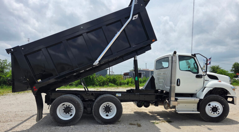 White International FL-15 with the black Warren frameless dump body fully raised in the dump position
