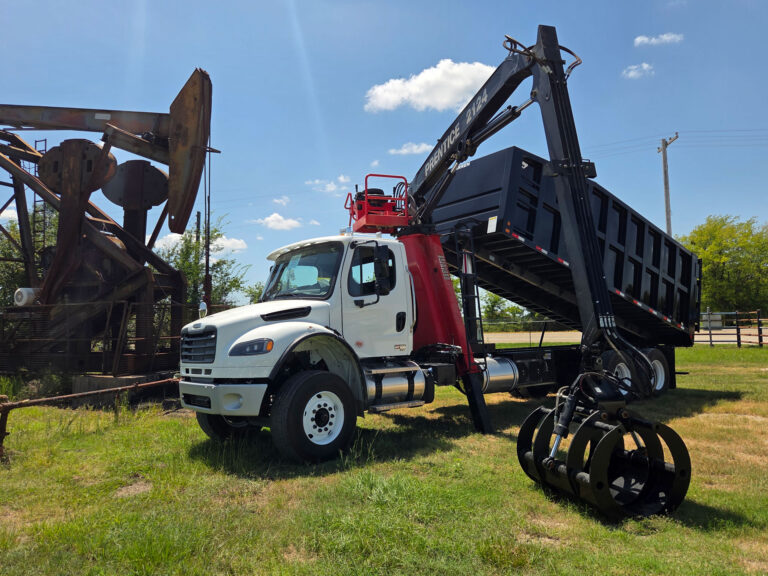 Freightliner grapple truck with red Prentice 2124 loader and Warren 22' frameless dump bed in Texas